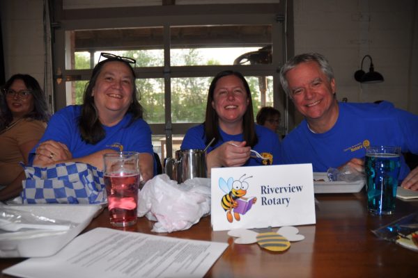 Riverview Rotary team members smile at their table during Danville Project Literacy’s JeopardBee event.