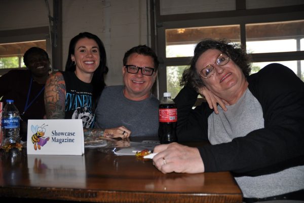 Showcase Magazine team members smile at their table during Danville Project Literacy’s JeopardBee event.