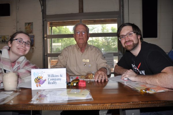 Wilkins & Company Realty team members sit at their table with trivia materials during Danville Project Literacy’s JeopardBee event.